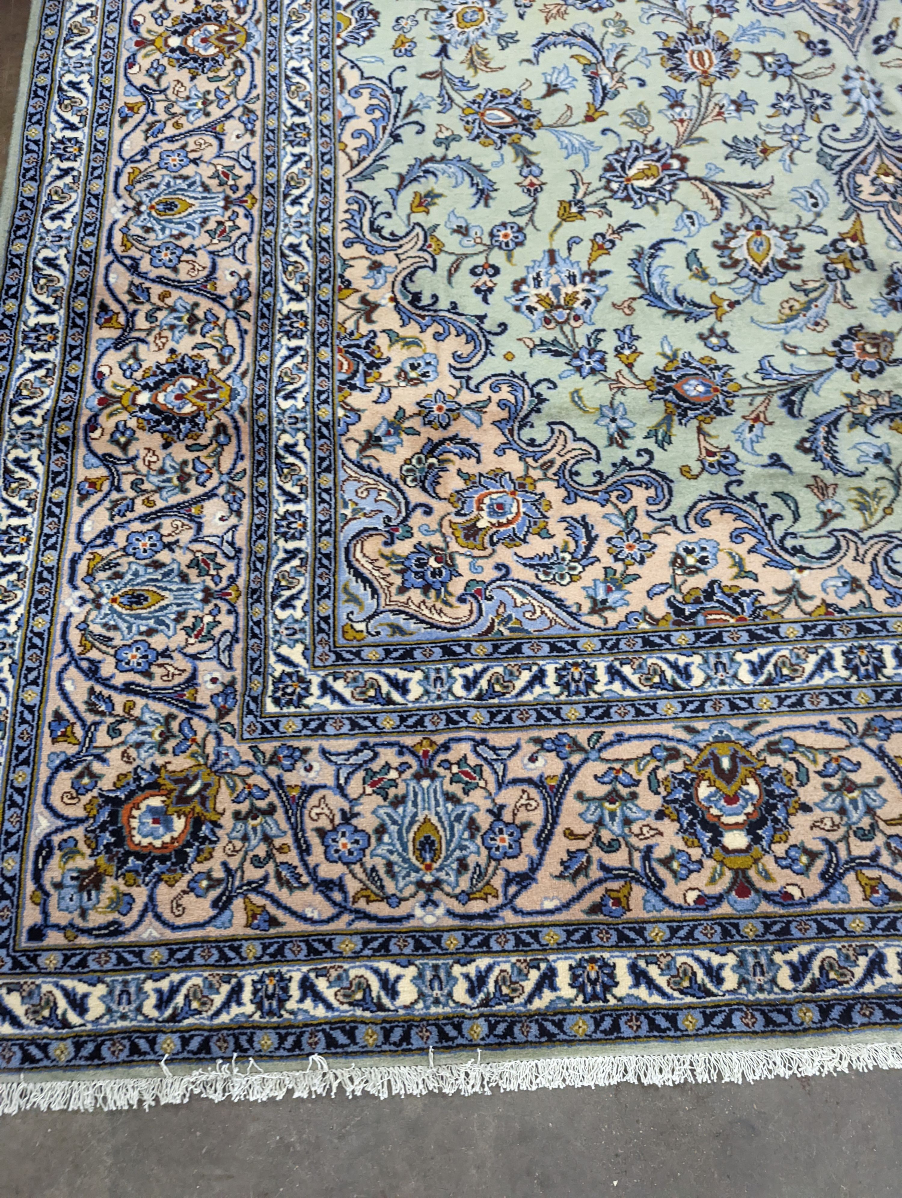 A Kashan pale green ground carpet, 410 x 296cm